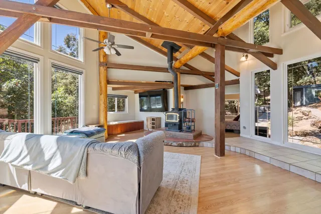 a living room with furniture and a floor to ceiling windows