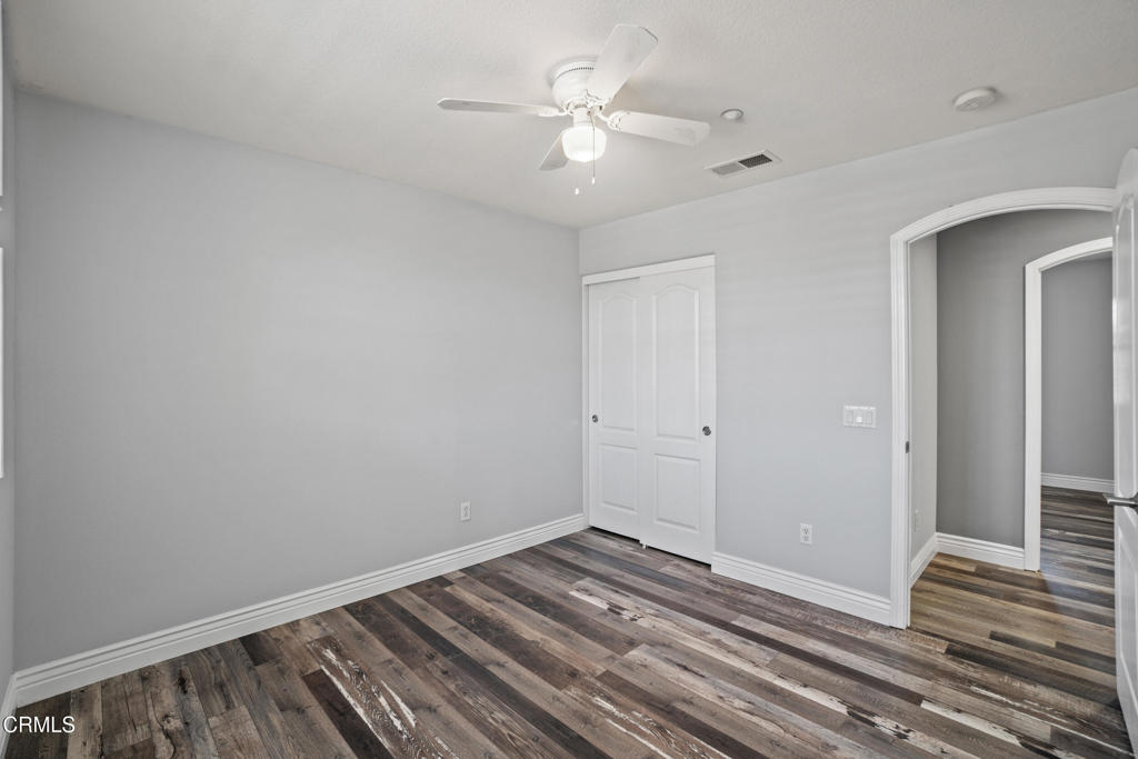 615 Halifax Lane Oxnard, CA 93035 - Photo 29 of 35 a view of a room with wooden floor and a ceiling fan