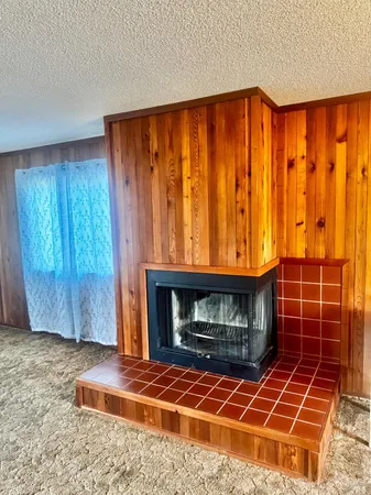 a room with a fireplace and a window