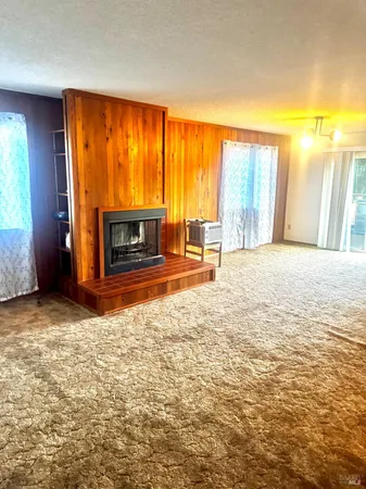 an empty room with furniture and a fireplace