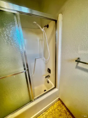 a bathroom with a glass shower door