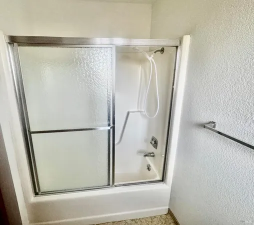 a bathroom with a glass shower door