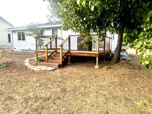 a view of a house with backyard porch and sitting area