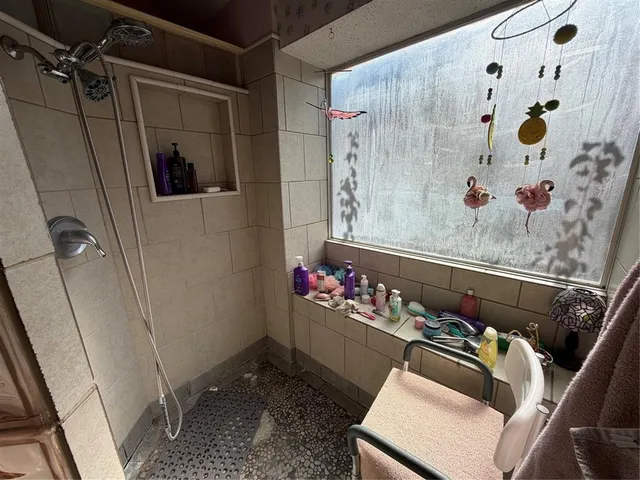 a room with lots of flowers and shower