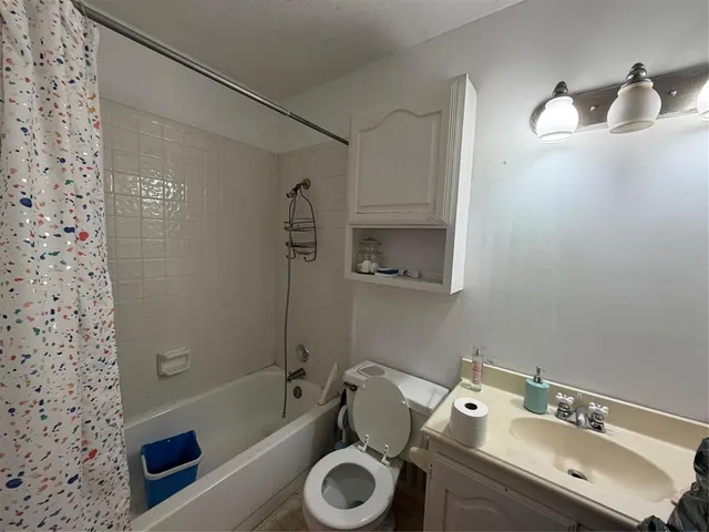 a bathroom with a sink mirror toilet and bathtub