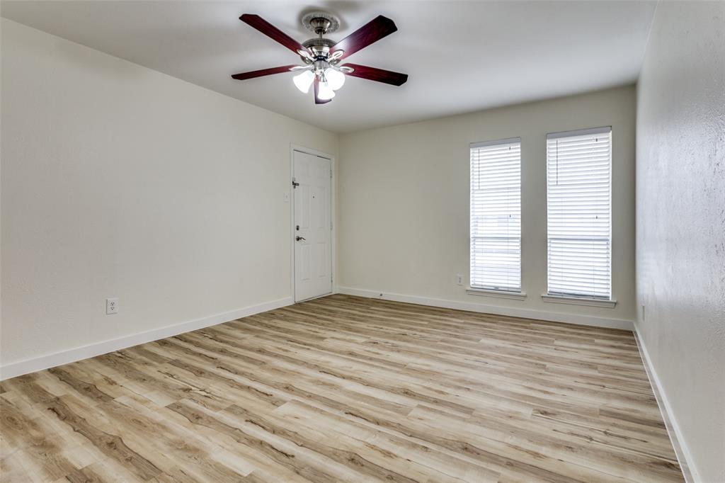 5844 Sandhurst Lane, Unit D Dallas, TX 75206 - Photo 18 of 31 wooden floor in an empty room with a window