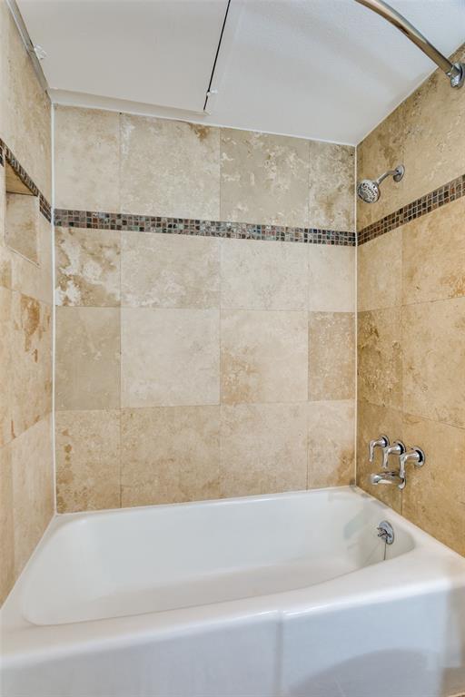 5844 Sandhurst Lane, Unit D Dallas, TX 75206 - Photo 26 of 31 a bathroom with a shower and a bathtub