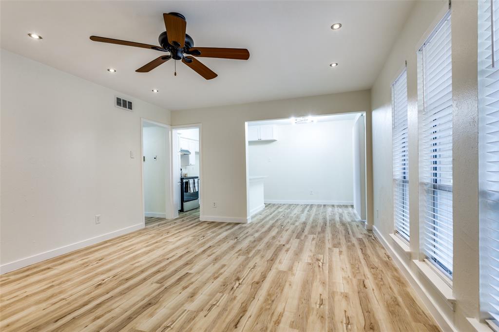 5844 Sandhurst Lane, Unit D Dallas, TX 75206 - Photo 7 of 31 a view of empty room with wooden floor and fan