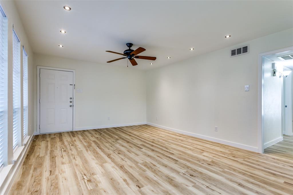 5844 Sandhurst Lane, Unit D Dallas, TX 75206 - Photo 8 of 31 a view of empty room with wooden floor and fan