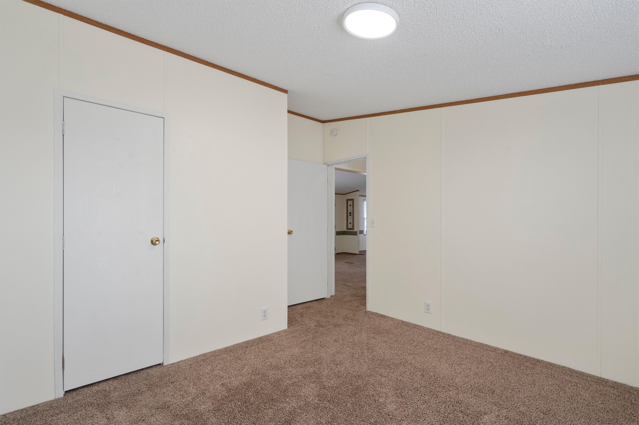 3075 Old Black Colony Road, Unit D Buda, TX 78610 - Photo 17 of 26 Smooth crown molding accents the neutral walls and soft carpeting of this versatile bedroom.