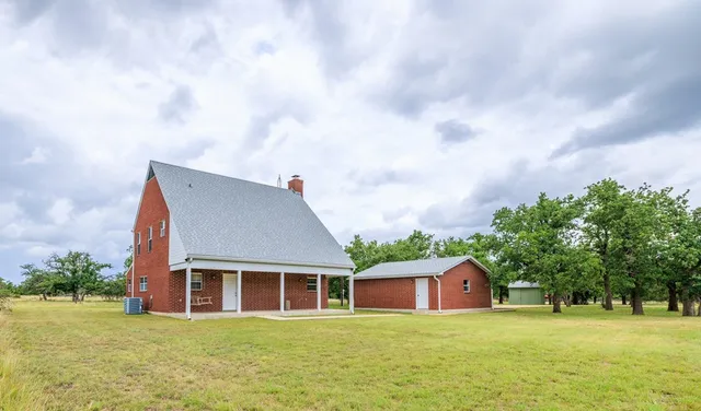 a view of a house with yard and sitting area