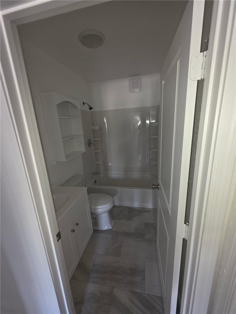 512 E Street Needles, CA 92363 - Photo 14 of 20 a bathroom with a glass door shower