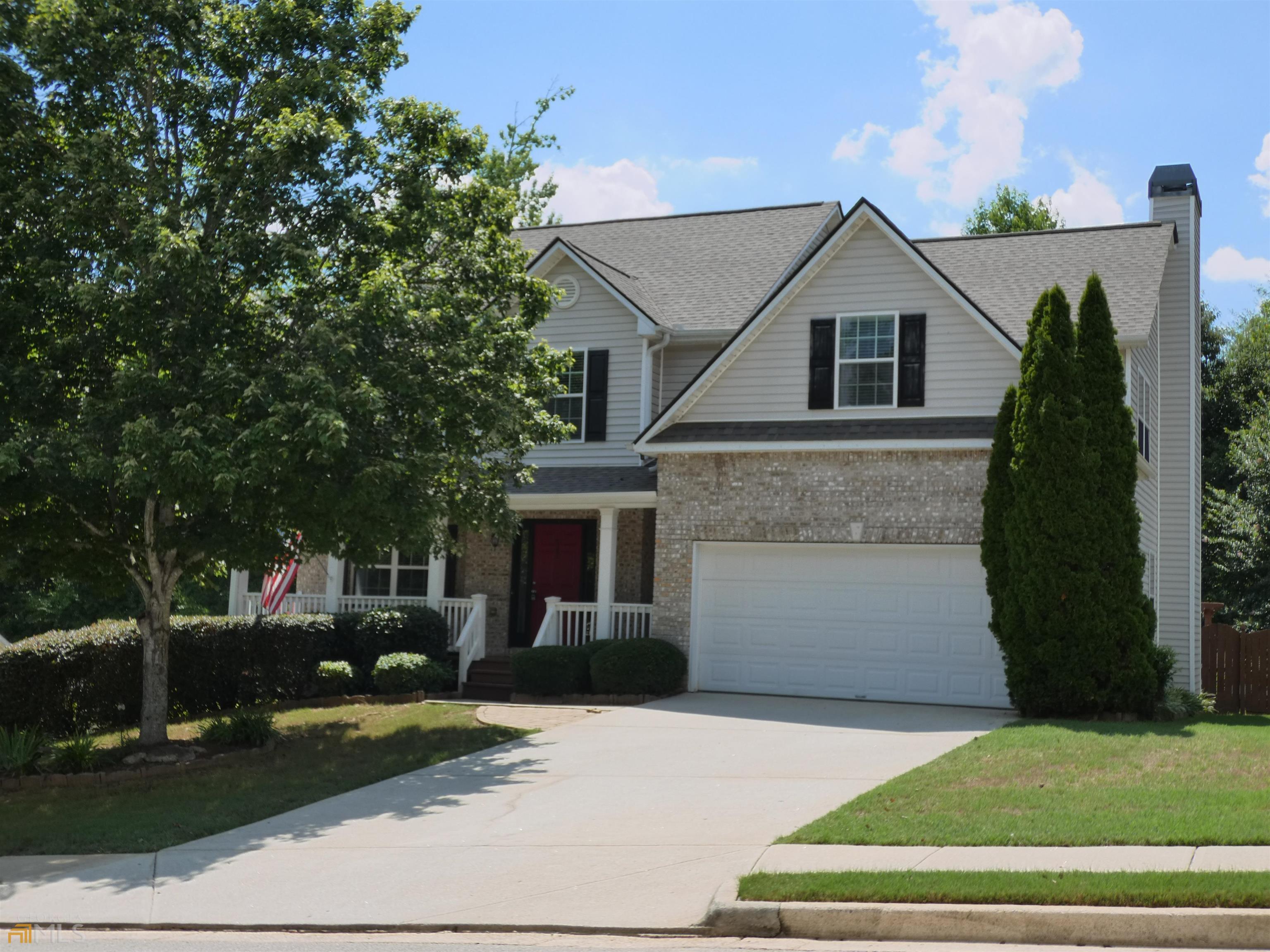 802 Thompson Ridge Drive Monroe, GA 30655 - Photo 1 of 1 a front view of a house with a yard and garage