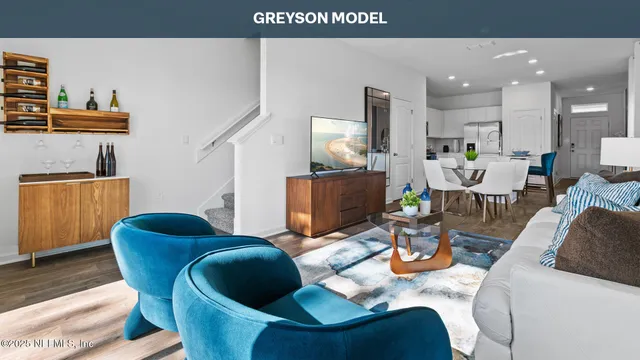 a living room with furniture and a painting