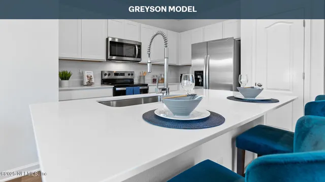 a kitchen with a refrigerator and a stove