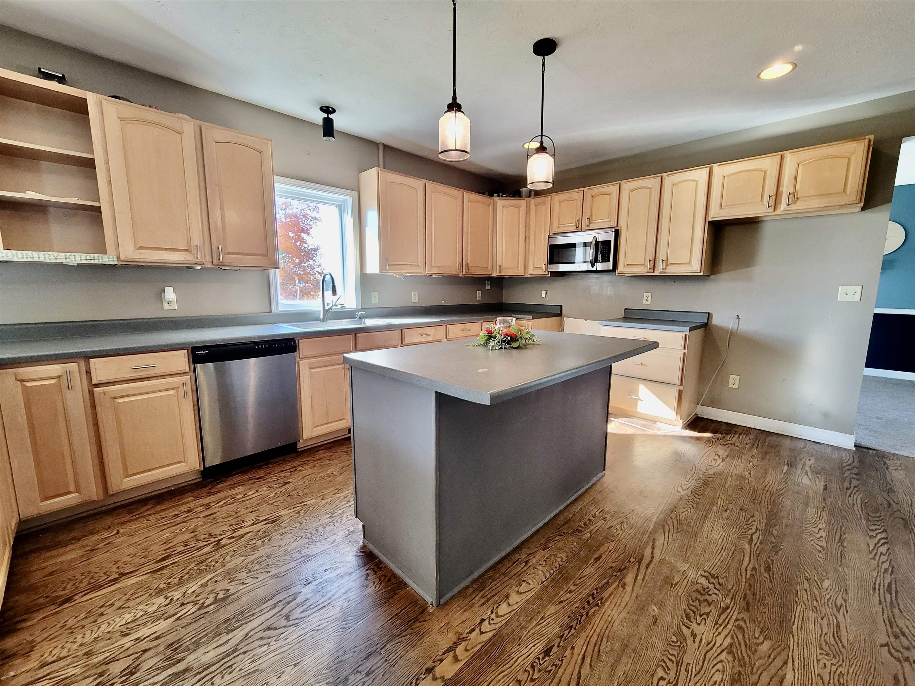 9205 East Scott Road Stillman Valley, IL 61084 - Photo 8 of 43 a kitchen with stainless steel appliances granite countertop a sink a stove and a wooden floors
