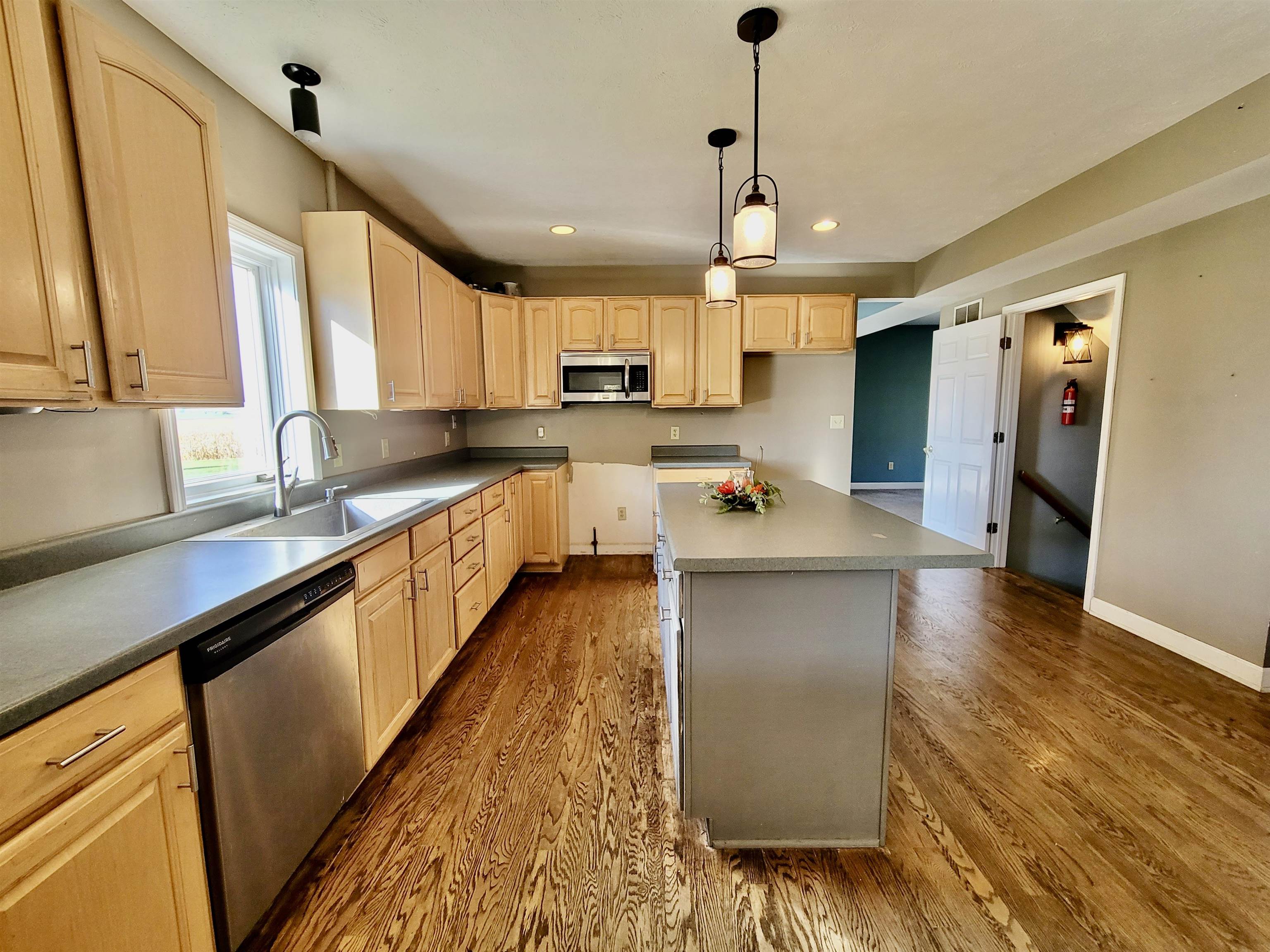 9205 East Scott Road Stillman Valley, IL 61084 - Photo 9 of 43 a large kitchen with kitchen island a large counter space a sink appliances and cabinets