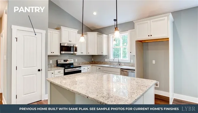 a kitchen with stainless steel appliances granite countertop a sink a stove and a refrigerator
