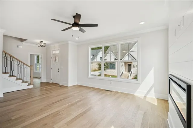 a large kitchen with kitchen island a sink stainless steel appliances and a chandelier