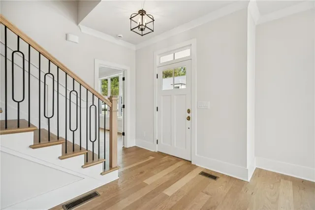 a view of a livingroom with a ceiling fan and entryway