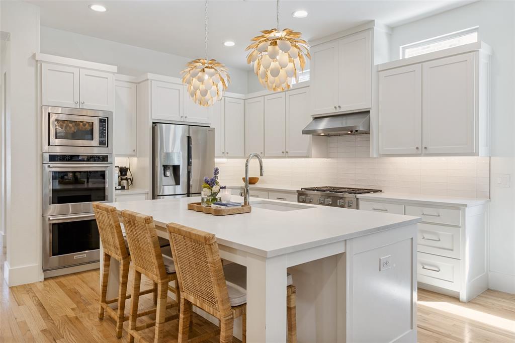 7533 Garonne Street Dallas, TX 75231 - Photo 6 of 32 a kitchen with a table chairs and microwave