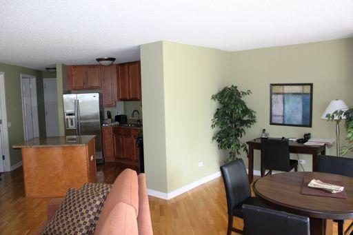 Undisclosed Address Chicago, IL 60654 - Photo 4 of 10 a view of a dining room with furniture a chandelier and wooden floor