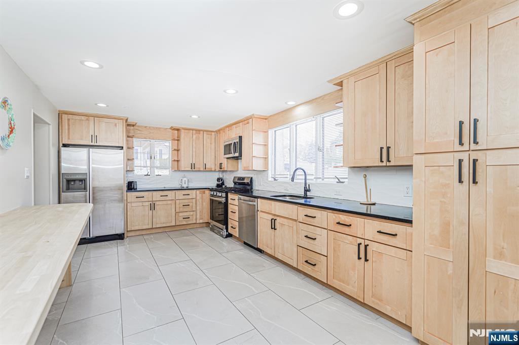566 Teaneck Road Teaneck, NJ 07666 - Photo 14 of 35 a large white kitchen with cabinets and stainless steel appliances