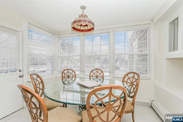 a view of a dining room and hall with furniture