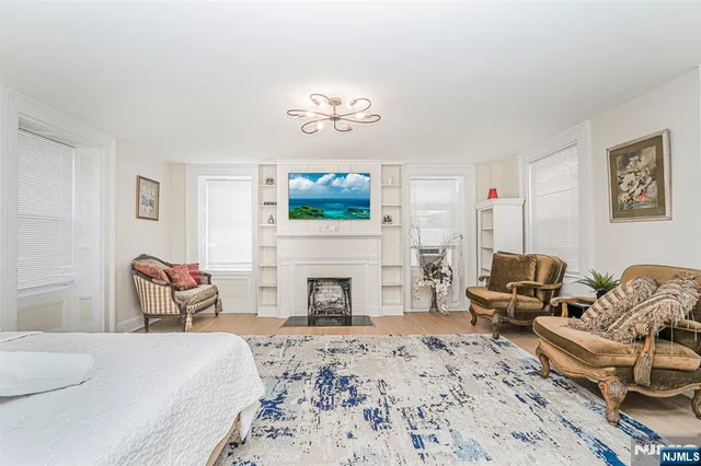 a bedroom with furniture fireplace and window