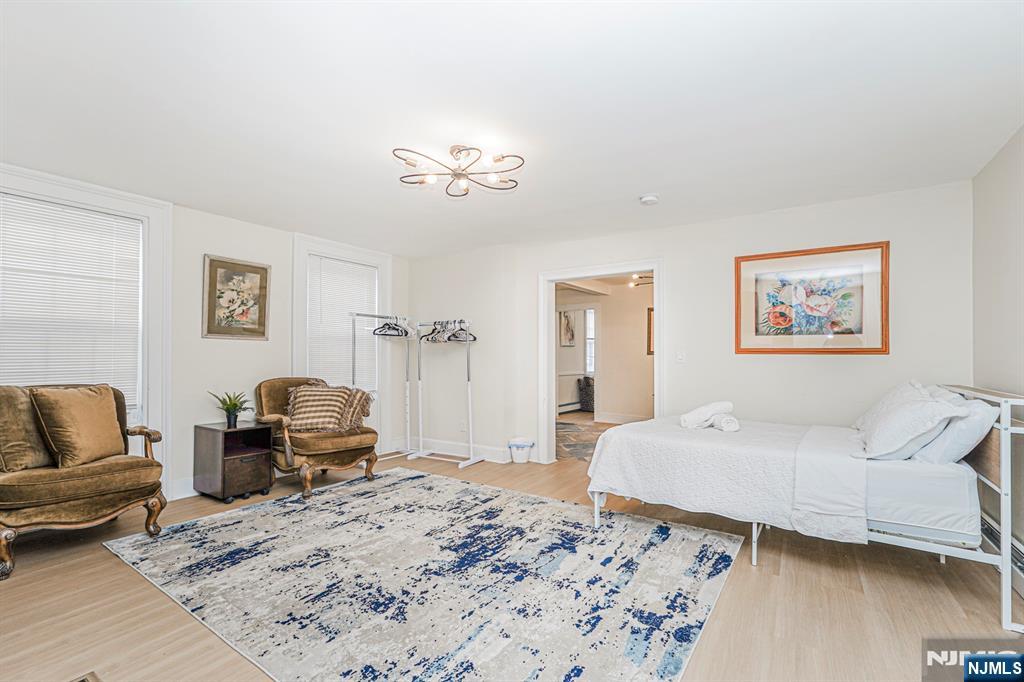 566 Teaneck Road Teaneck, NJ 07666 - Photo 21 of 35 a bedroom with a bed couch and wooden floor