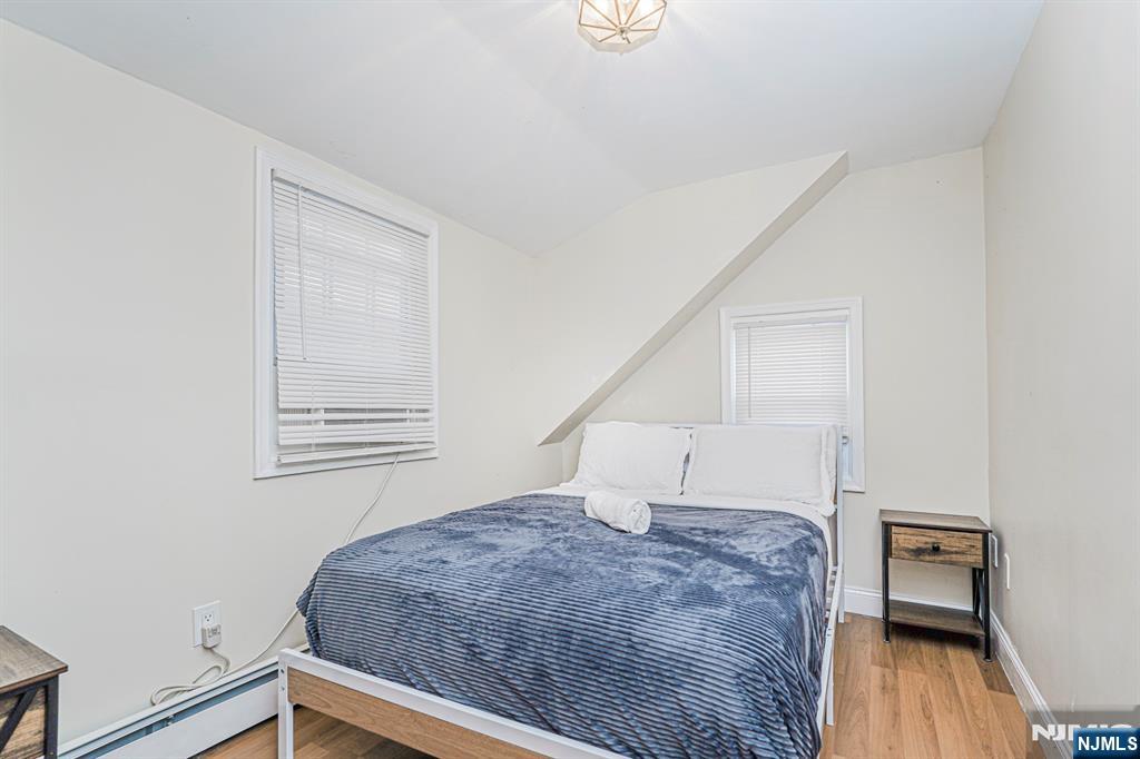 566 Teaneck Road Teaneck, NJ 07666 - Photo 24 of 35 a bedroom with a bed and wooden floor