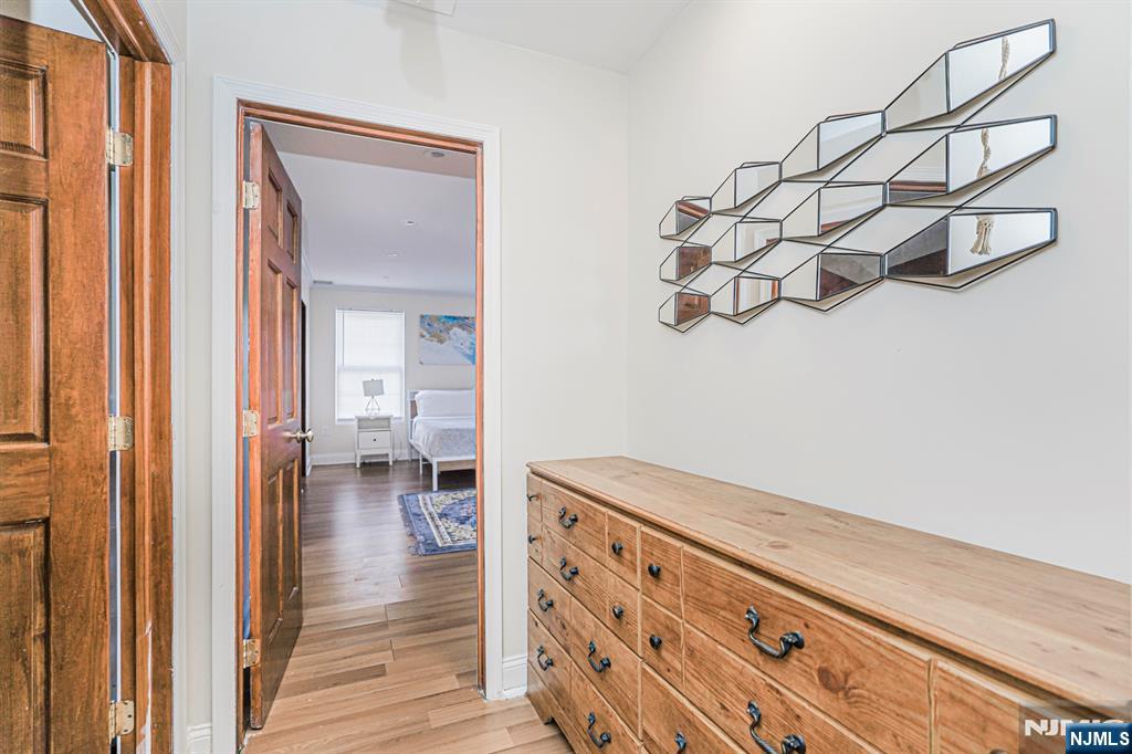 566 Teaneck Road Teaneck, NJ 07666 - Photo 25 of 35 a view of a hallway with wooden floor and staircase