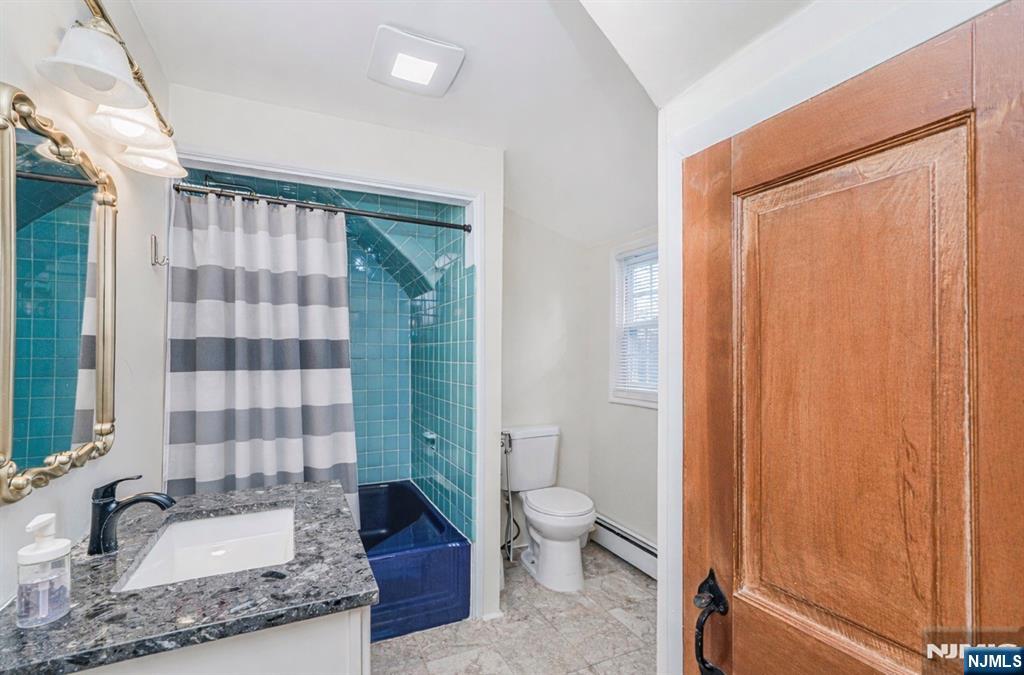 566 Teaneck Road Teaneck, NJ 07666 - Photo 33 of 35 a bathroom with a granite countertop sink toilet and shower