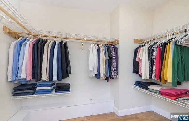 a view of walk in closet with clothes
