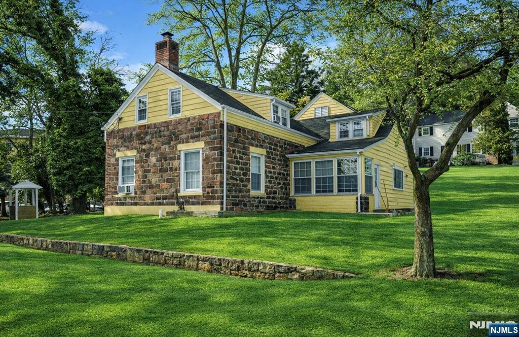 566 Teaneck Road Teaneck, NJ 07666 - Photo 4 of 35 a front view of a house with a garden