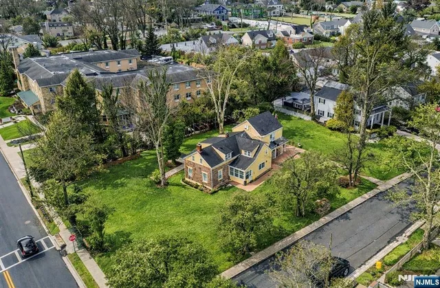 an aerial view of a house with garden space and street view