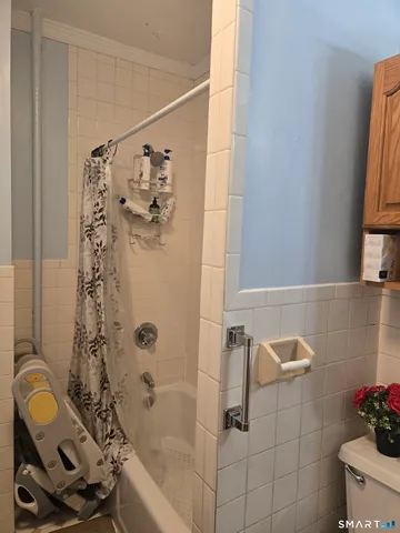 a bathroom with a shower and a sink