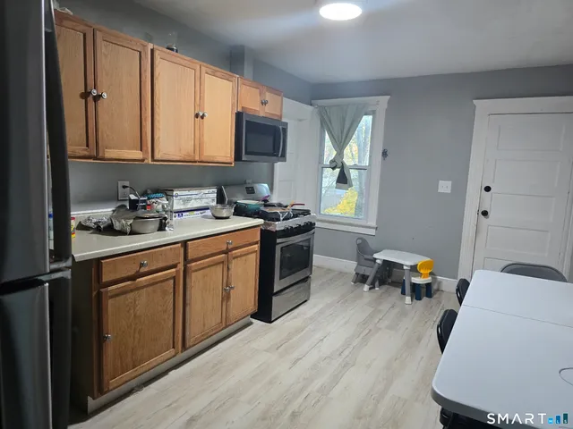 a kitchen with a sink stove and cabinets