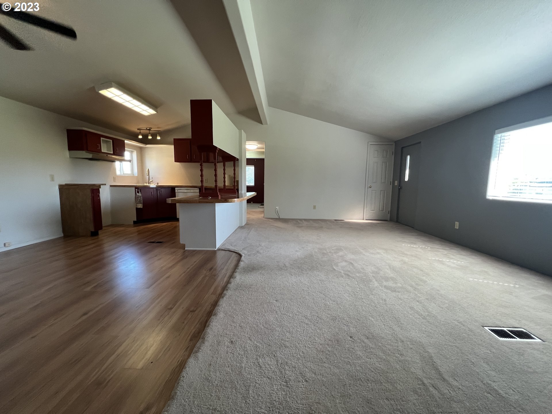 80204 South Edwards Road Hermiston, OR 97838 - Photo 18 of 27 a view of a living room with kitchen and wooden floor