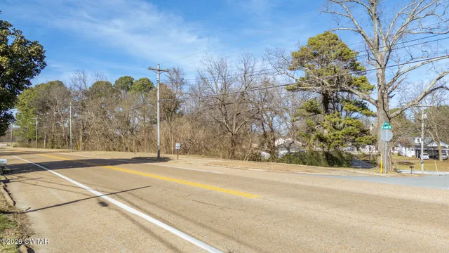 a view of a yard with wooden fence