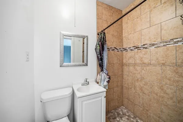 a bathroom with a toilet sink and shower