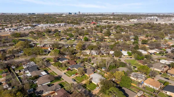 an aerial view of a residential houses with outdoor space
