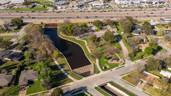 an aerial view of a house with a garden and swimming pool