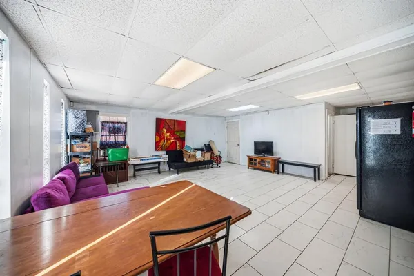 a living room with lots of furniture and a wooden floor