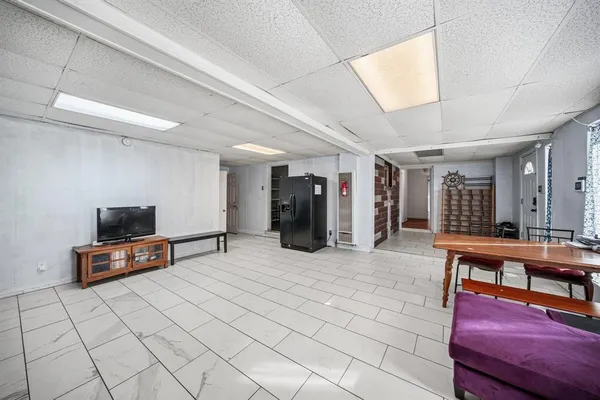 a living room with furniture a flat screen tv and a table