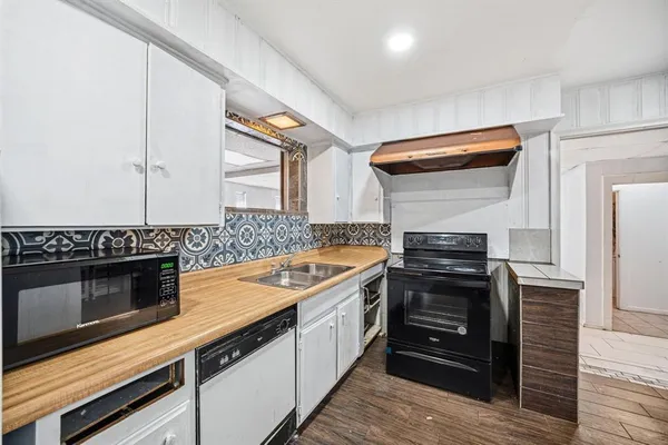a kitchen with stainless steel appliances granite countertop a stove and a refrigerator