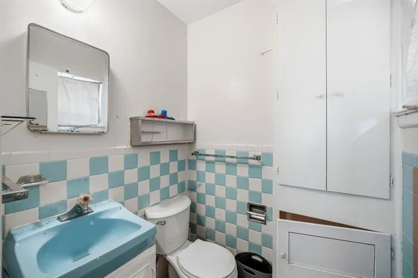 a bathroom with a sink a toilet and shower curtain