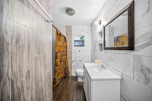 a living room with furniture a air conditioner and a window