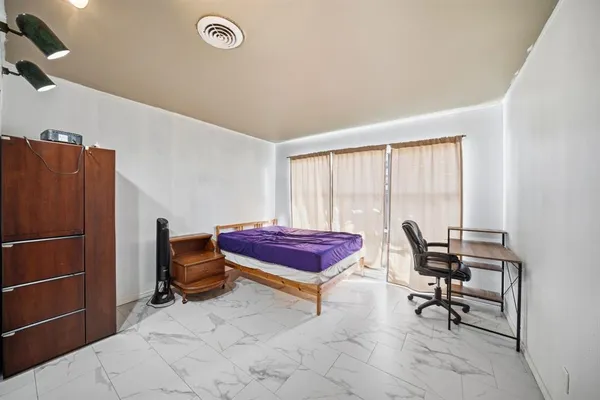 a bedroom with a bed a desk and chair