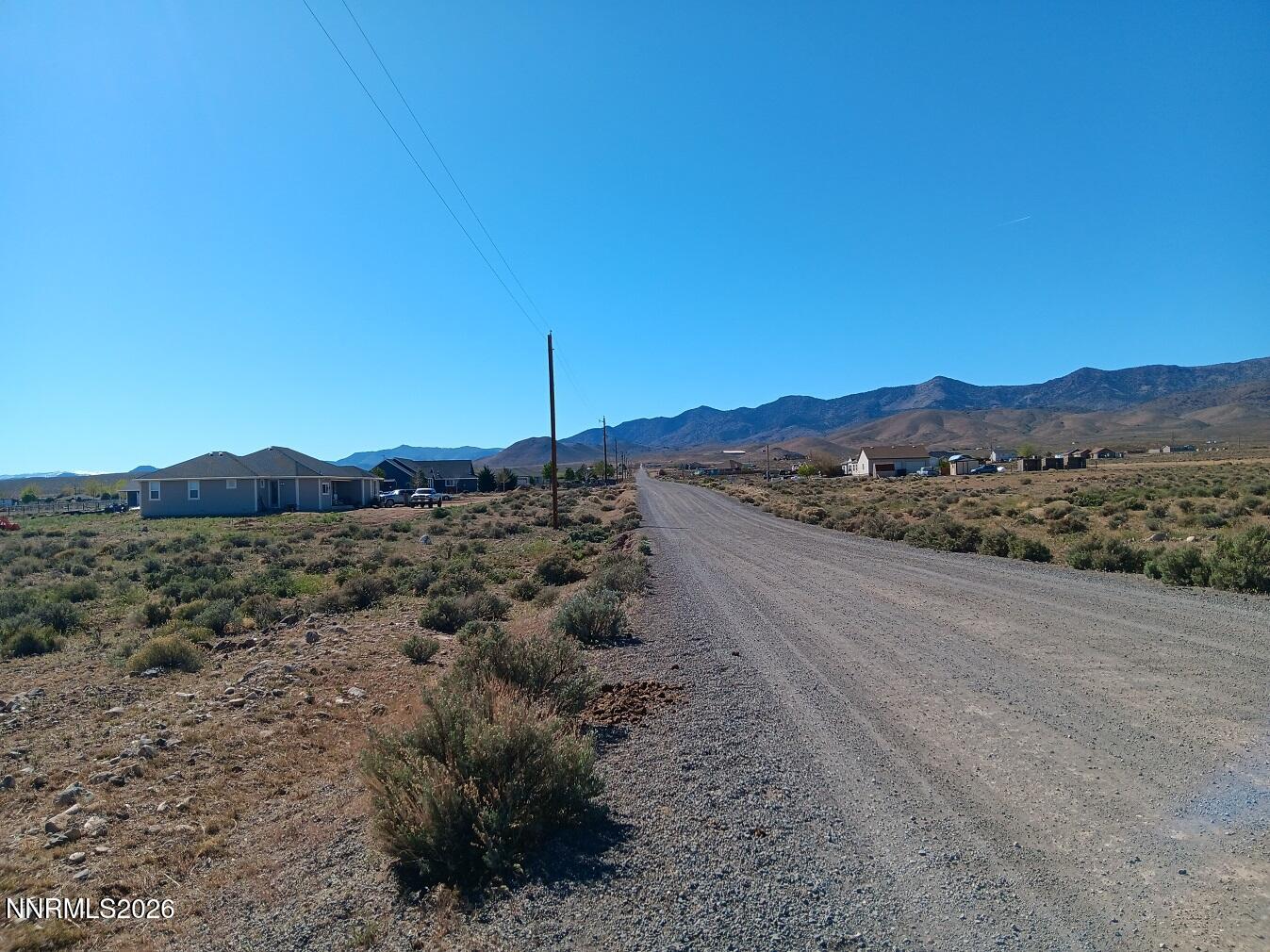 12405 Seneca Road Stagecoach, NV 89429 - Photo 6 of 6 a view of a dry field with mountains in the background